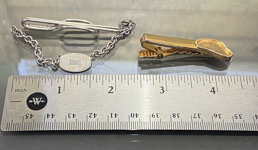 Two Tie Clips, One Marked Anson