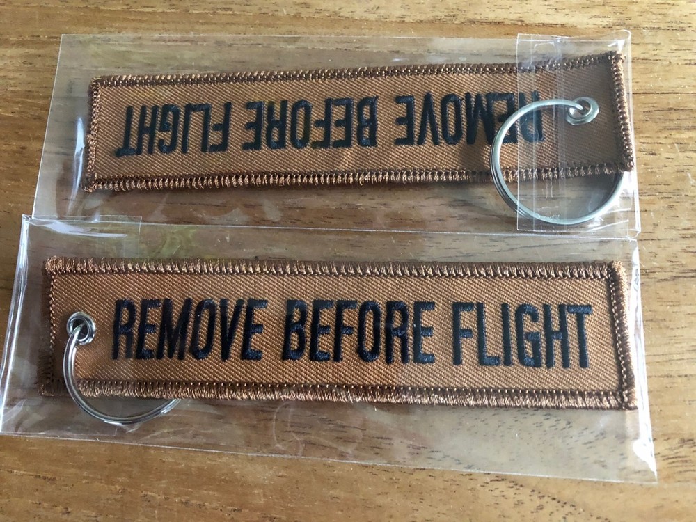REMOVE BEFORE FLIGHT  embroidered keychain Brown color