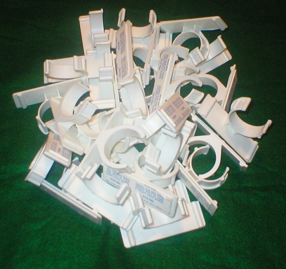 25 WHITE PLASTIC HOLDERS WITH ADHESIVE STRIPS LOT SOLD AS IS