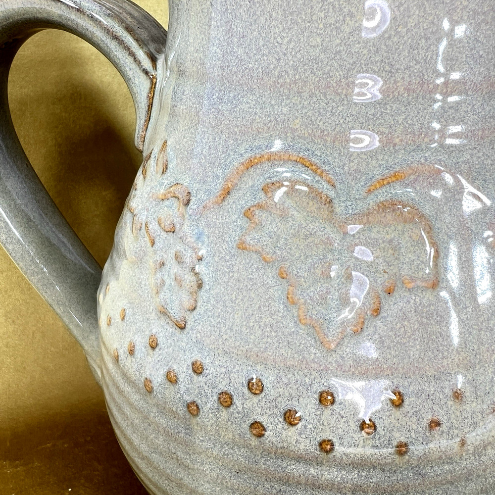 Unbranded Glazed Stoneware Pitcher embossed with fruit and glazed inside