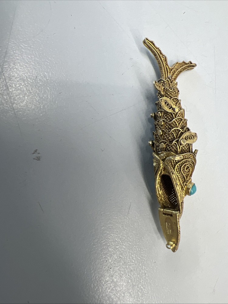 Tested as silver and gilded flexible fish, possibly pill box.