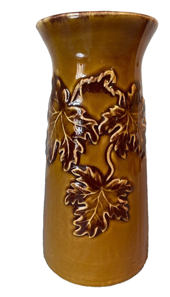 Handmade brown ceramic vase with leaves