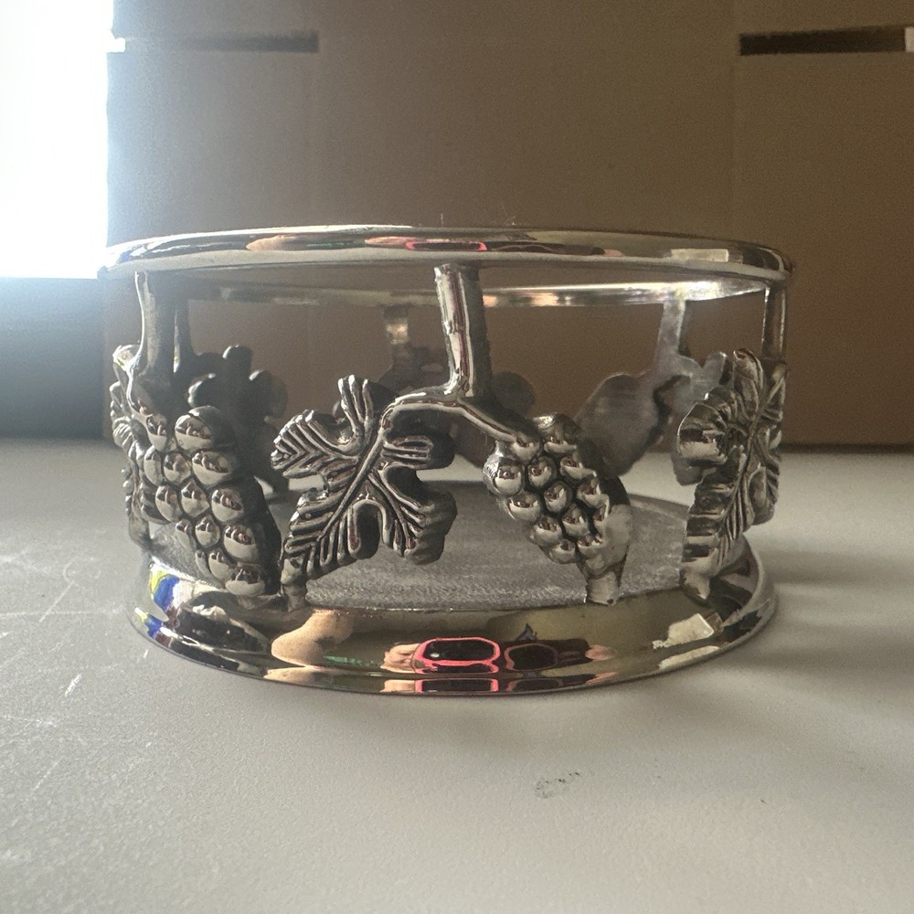 vintage, silver-plated wine bottle coaster featuring intricate grapevine pattern