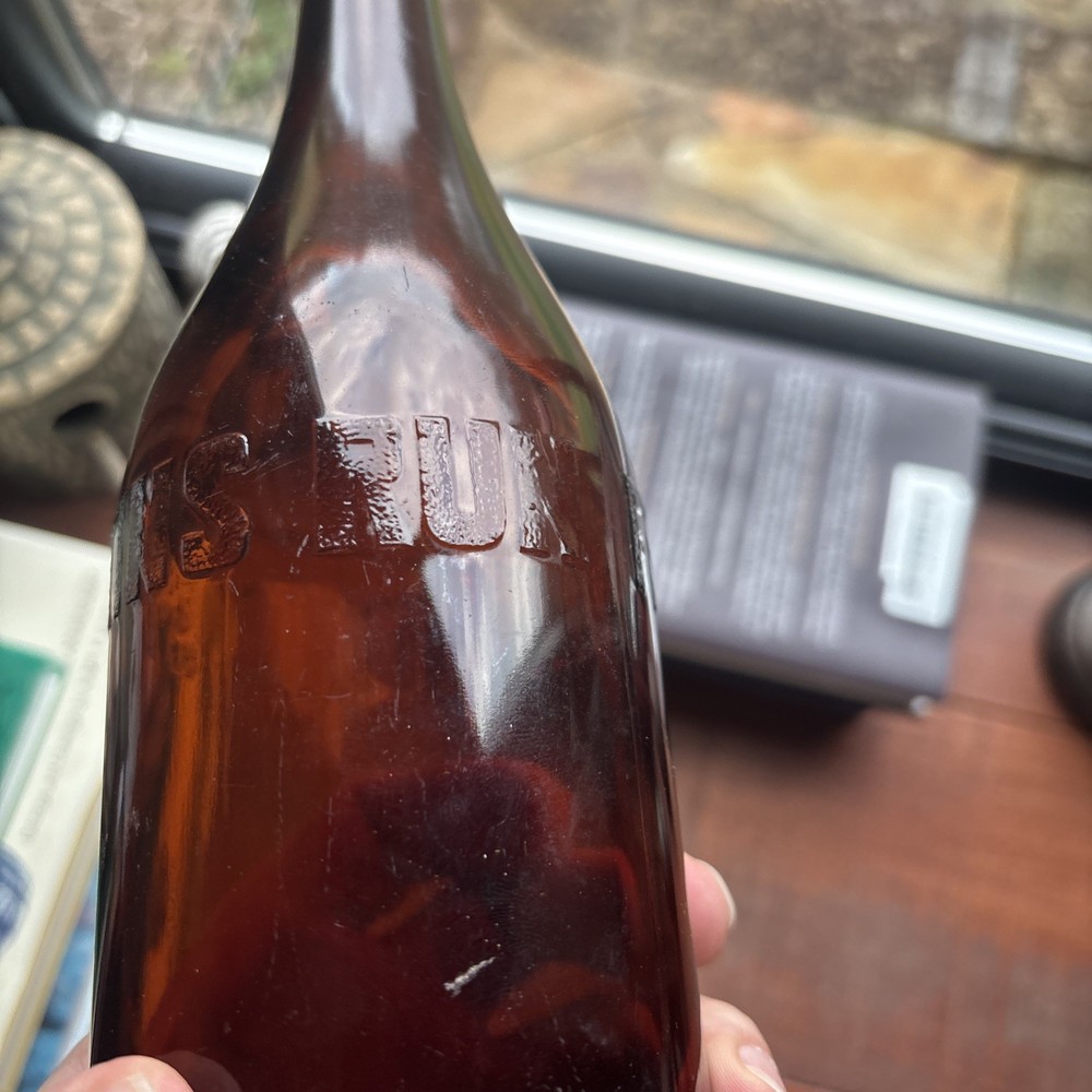 Stains Run From 101 Amber Embossed Bottle