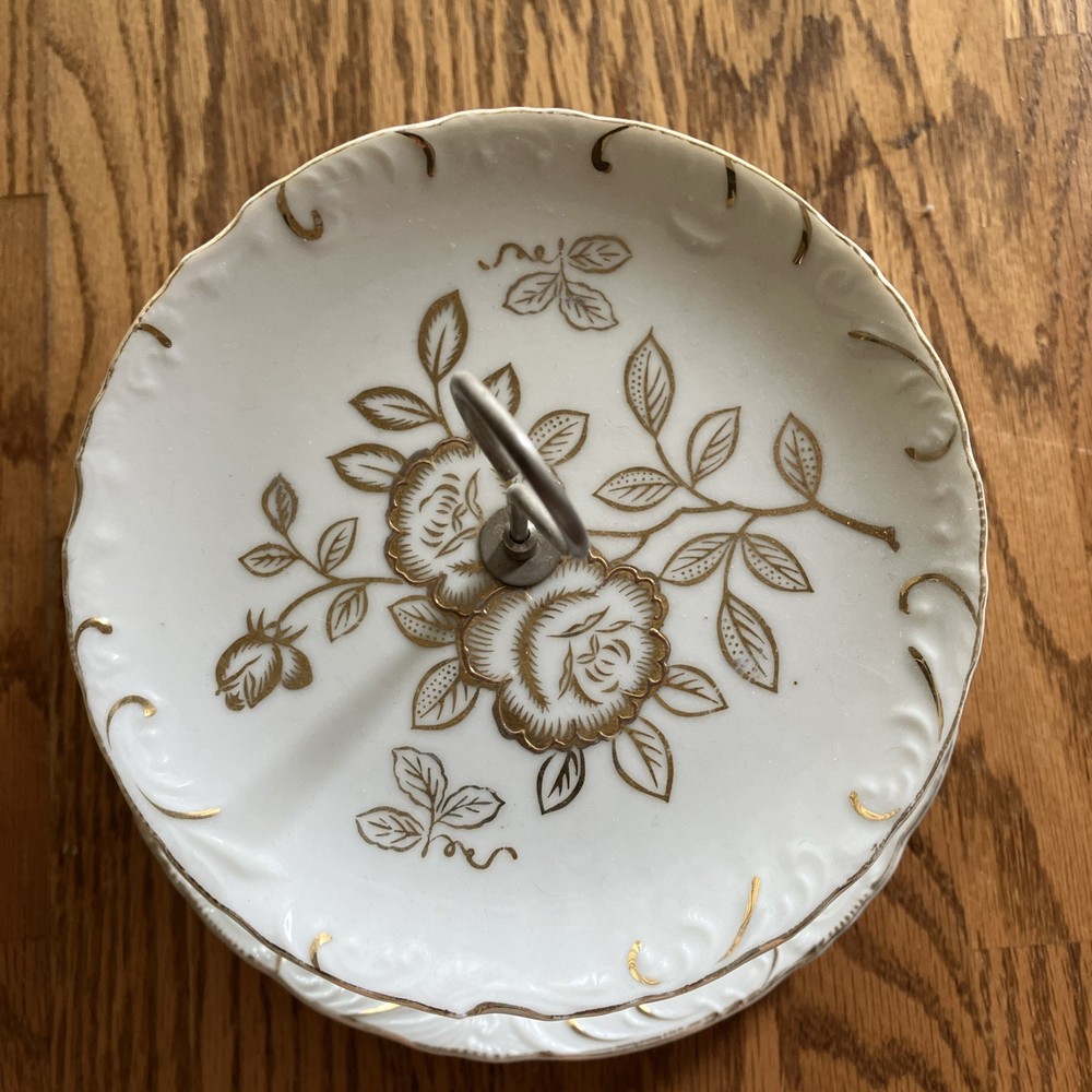Vtg white two-tiered tidbit server. Gold rose pattern & looped metal handle.