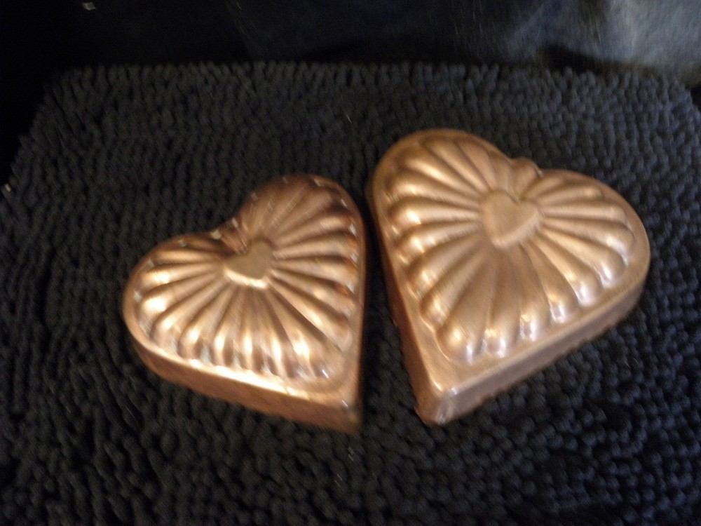 Pair of different size copper heart molds