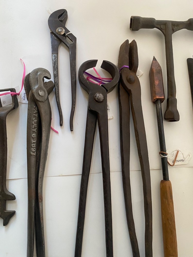 Collection of vintage blacksmithing and farrier tools
