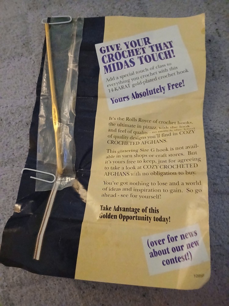 gold plated crochet hook with original ad page