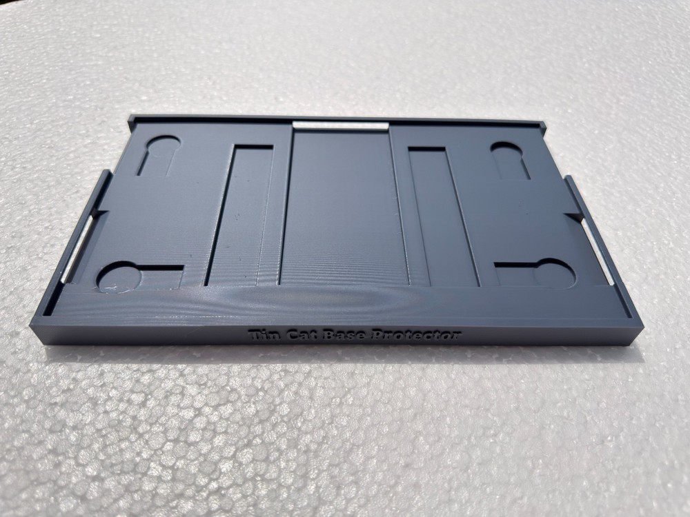 Tin cat mouse trap base protector.