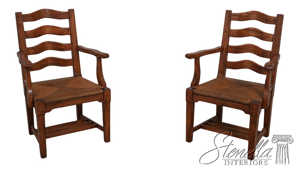 68471: Pair GUY CHADDOCK Distressed Ladderback Armchairs