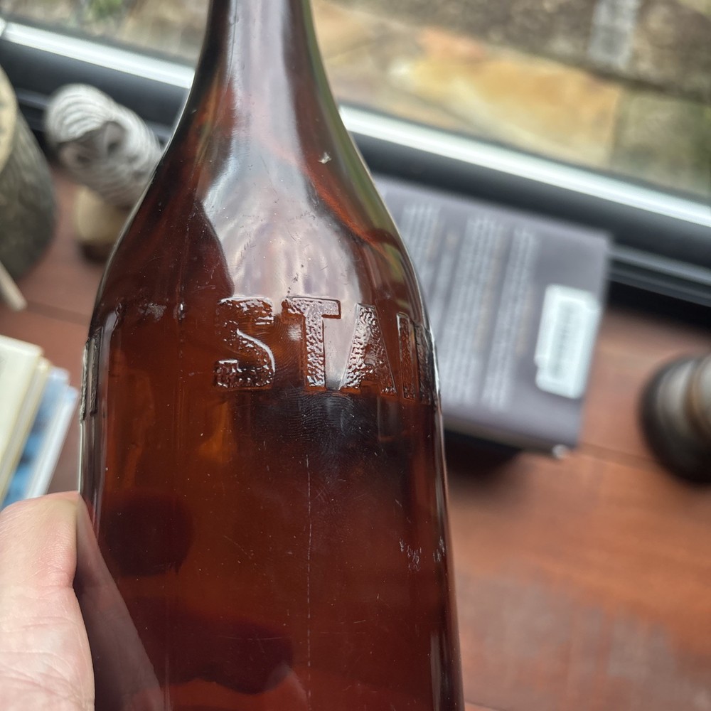 Stains Run From 101 Amber Embossed Bottle
