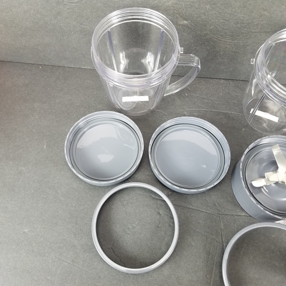 NutriBullet Mixed Lot Replacement Short Mixing Cups Handled Cup Lids Blade