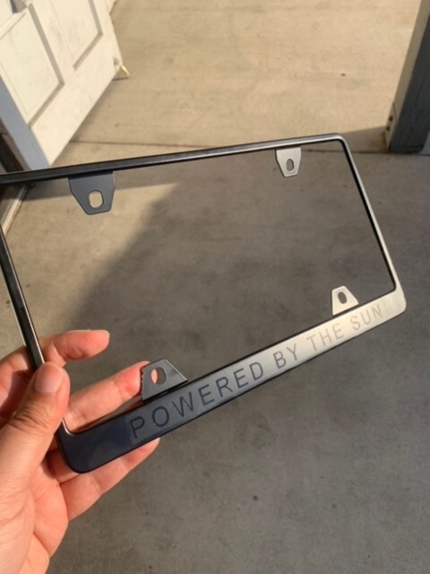 Powered By the Sun Tesla Black License Plate Frame