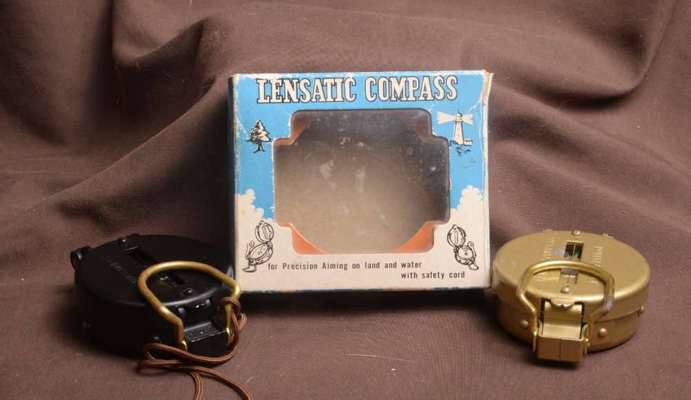two lensatic compasses one with box