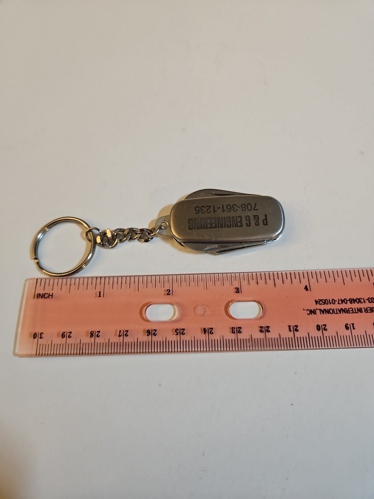 multi tool key chain stainless steel With P&G engineering On It.