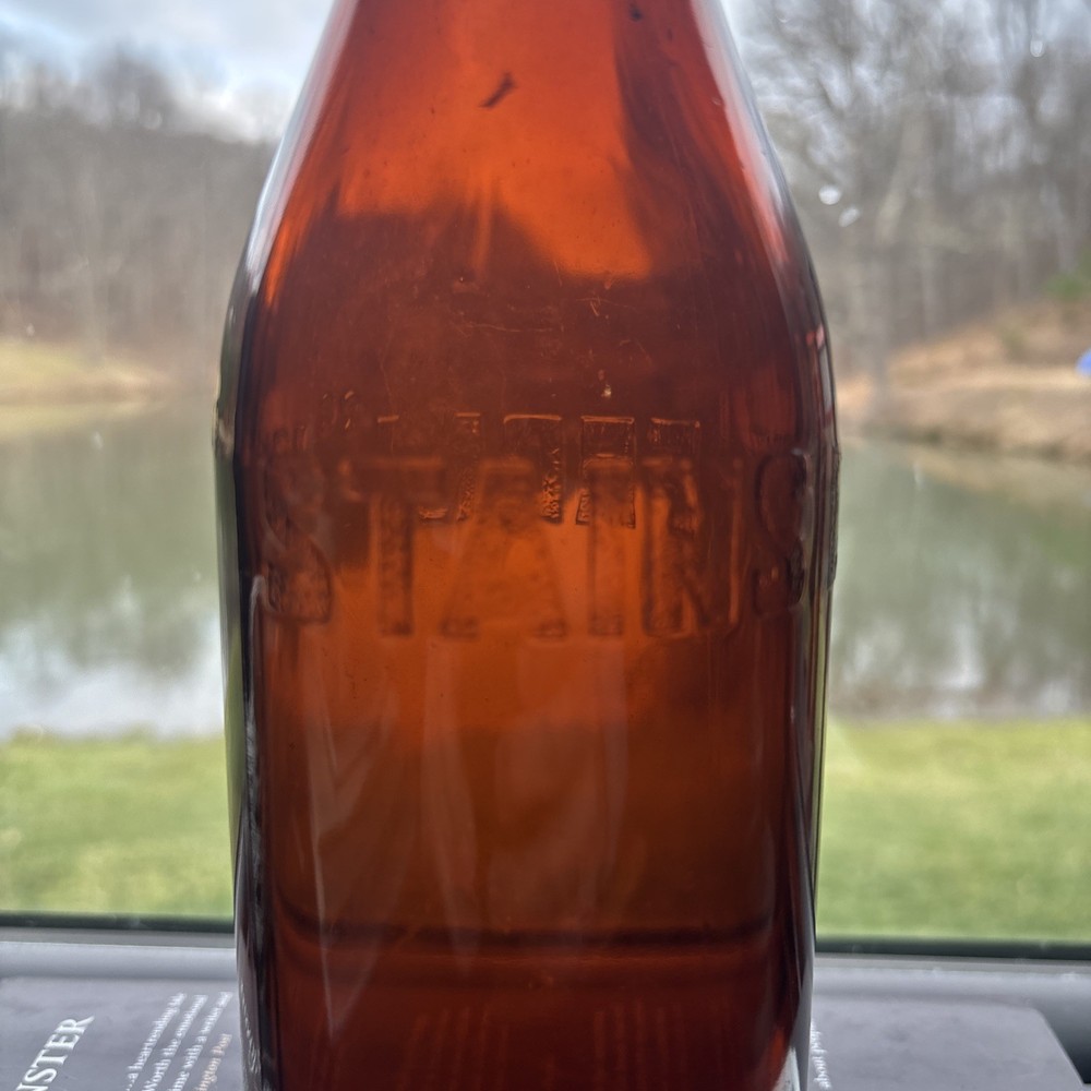 Stains Run From 101 Amber Embossed Bottle