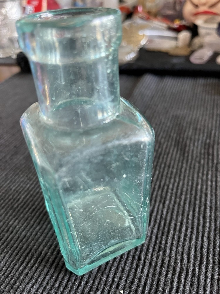 Embossed Aqua Kavu Boot Polish Bottle