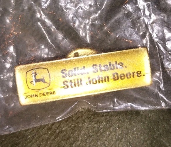 Vintage John Deere lapel or hat pin.