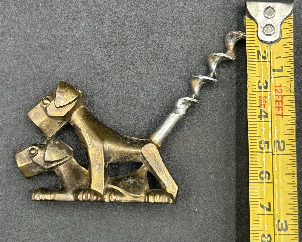 ART DECO CORKSCREW SOLID BRASS DOG. MARKED ENGLAND.