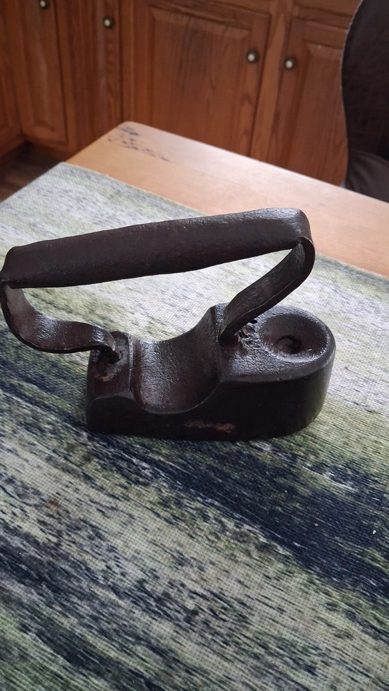 Antique 19th-century cast iron flat iron with a solid handle.