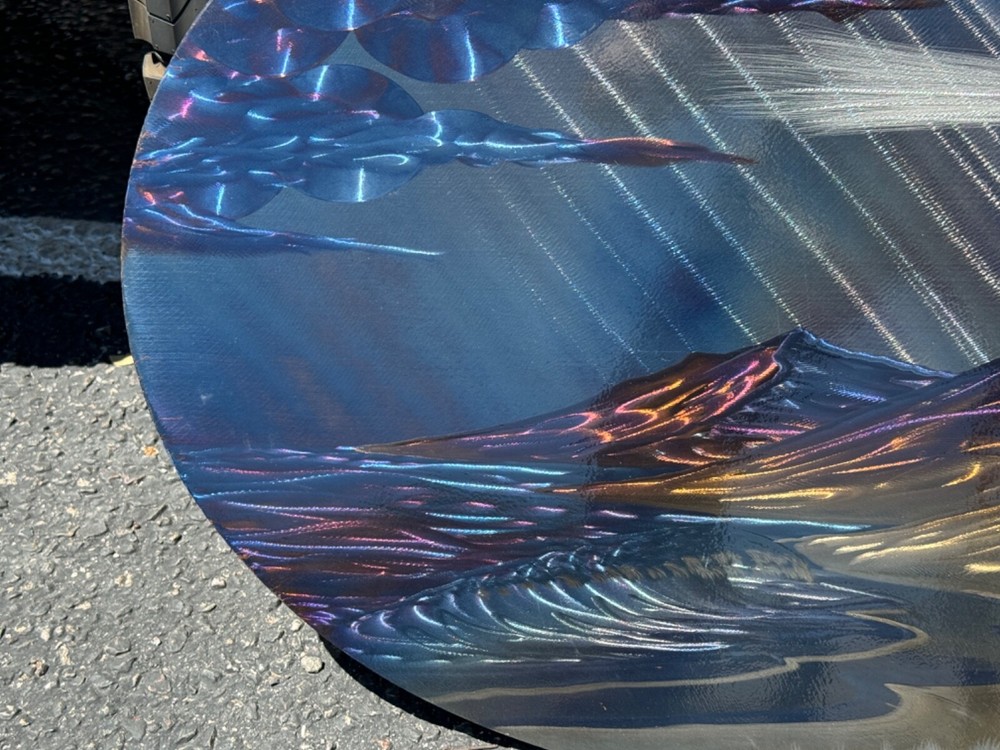 lasar etched artwork on metal lighthouse seascape