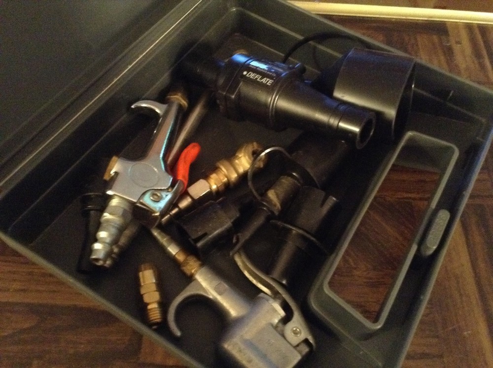Plastic case full of air attachments etc.