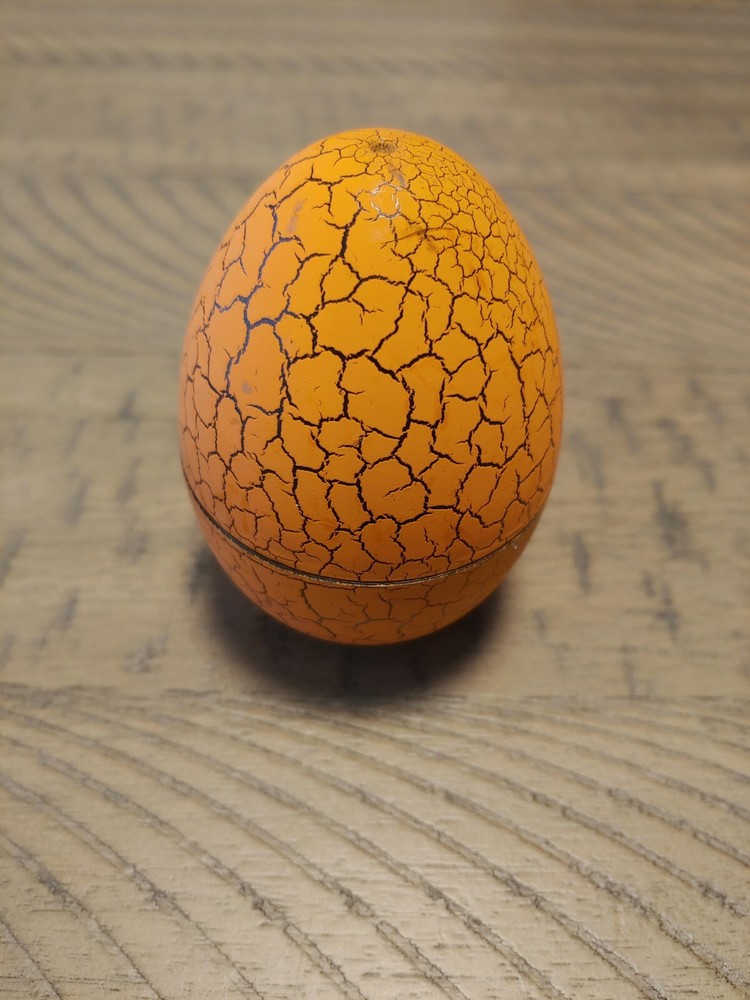 Orange Tamagotchi with dinosaur egg
