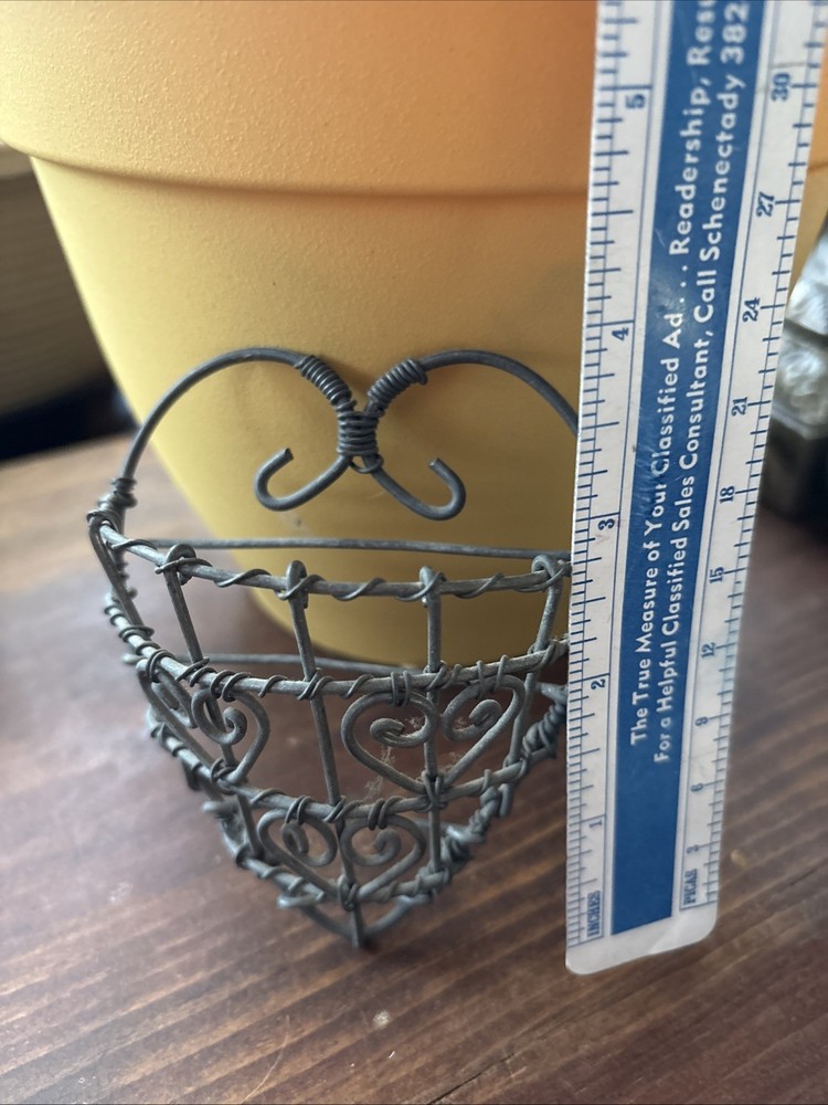 rustic, heart-shaped wire basket with scrollwork details.