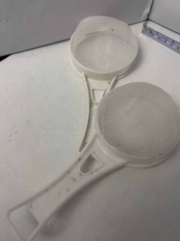 2 White handheld plastic handle sifters