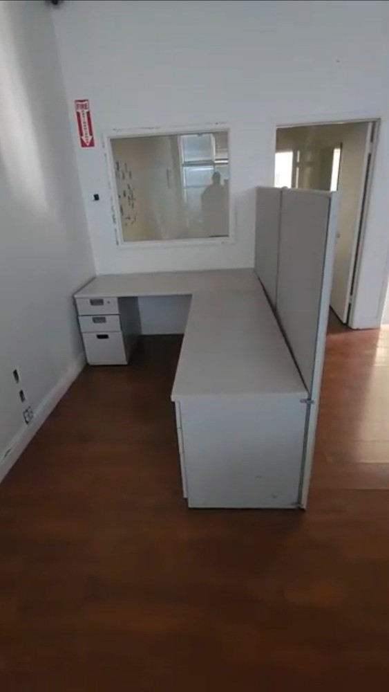 Eight used office cubicles and office desk.