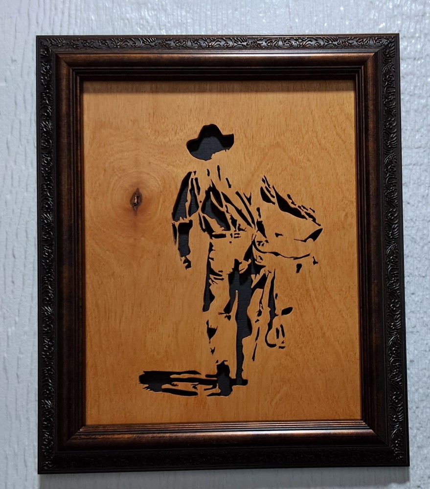 Cowboy with Saddle Handcut scrollsaw, framed, varnished, black backing