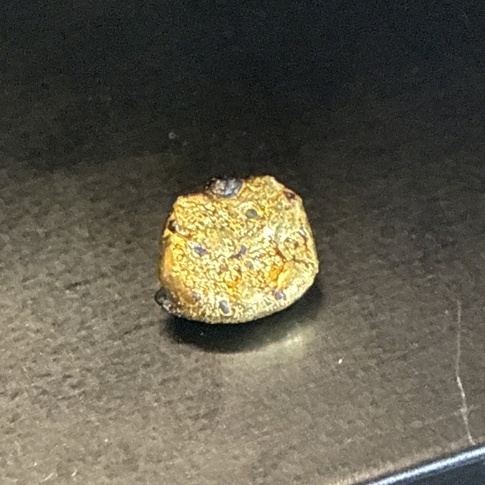 Gold nugget with small iron deposits