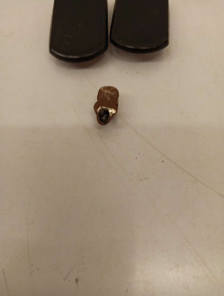 Two Driven Skull Dog Tags And Miniature Skull