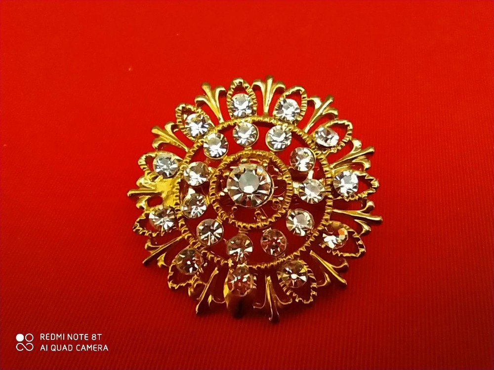 Base metal brooch with stones