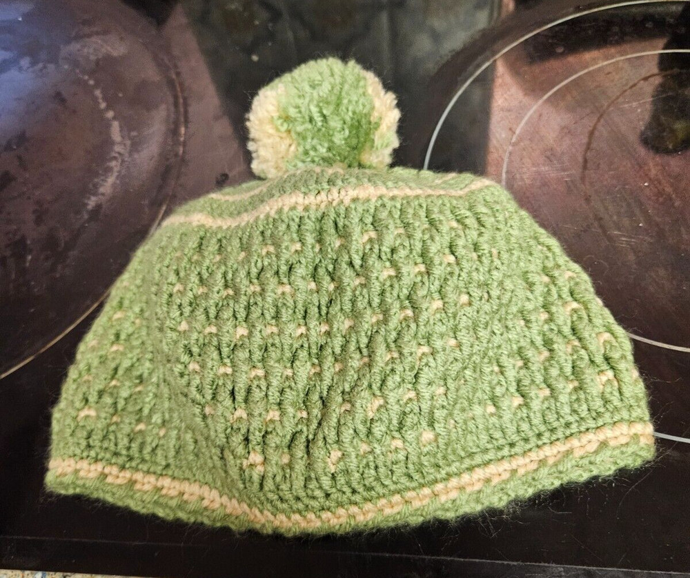 hand crocheted green childs hat with pompom