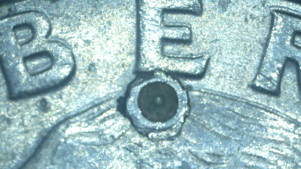 1991 Washington Quarter with a (strike through)