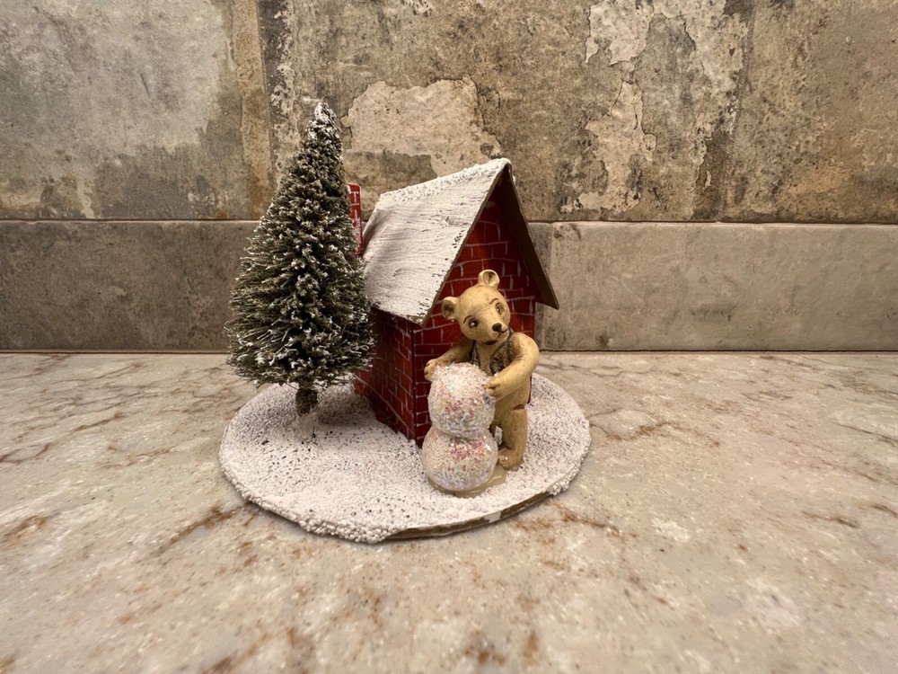 Snow Covered House With Bear Building A Snowman