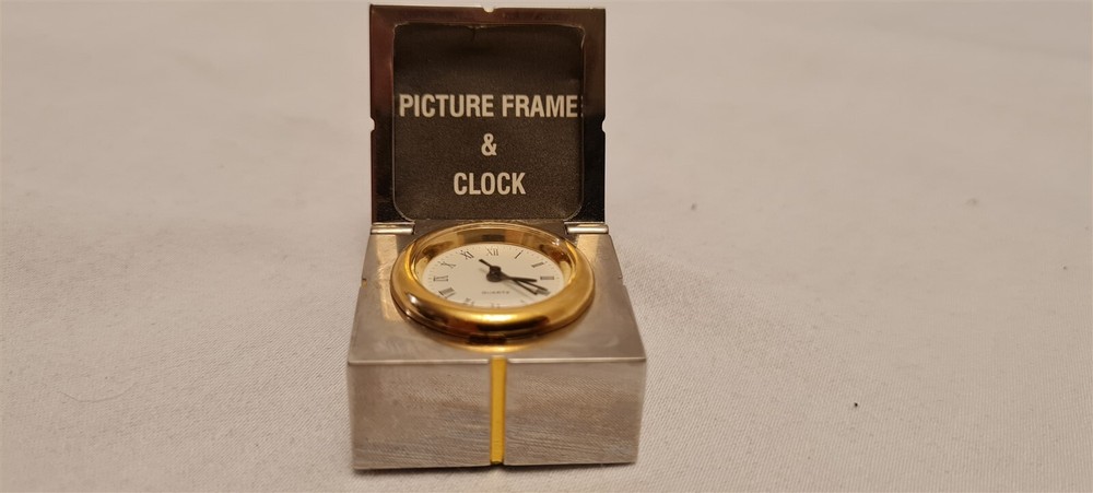 Gift mini clock with silver picture frame hidden inside gold trim