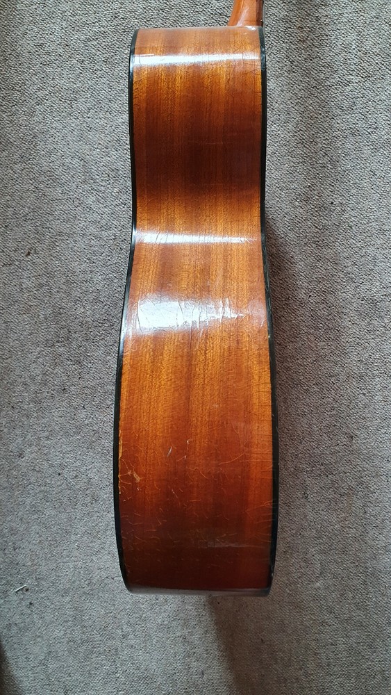 Old guitar with a nicely flamed back, needs service