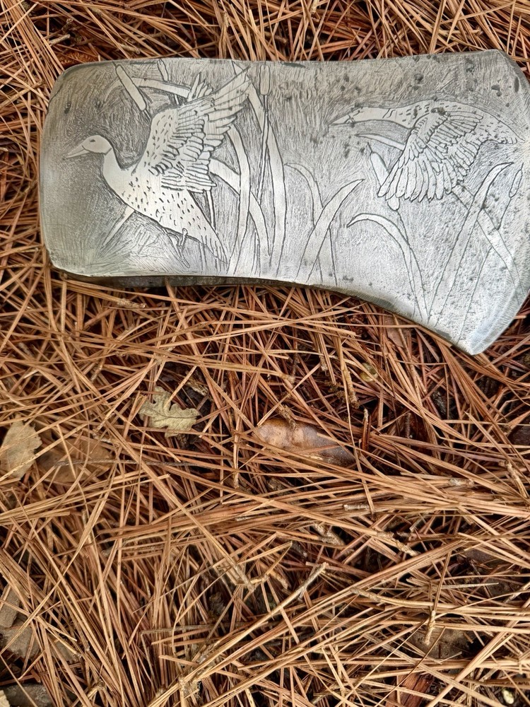 Single Bit Axe With A Duck Scenery Etched On Both Sides.