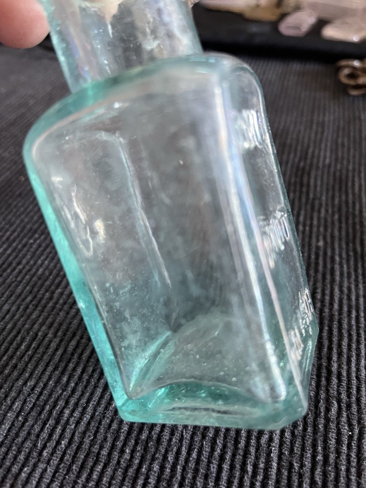 Embossed Aqua Kavu Boot Polish Bottle