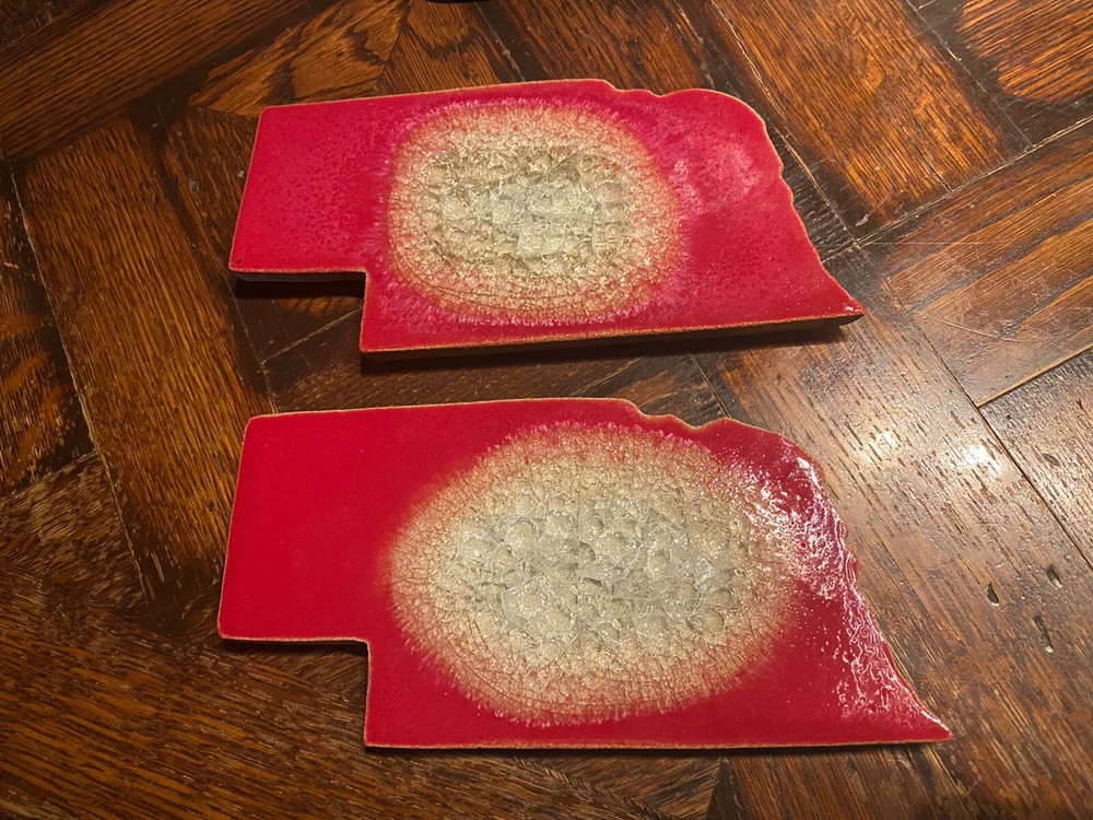 Two DOCK 6 Pottery “Nebraska” COASTERS trivets Red Glaze Geode design
