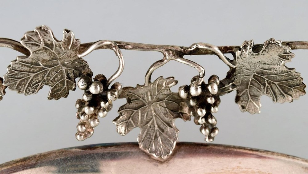 Large silver bowl pierced with grape vines.