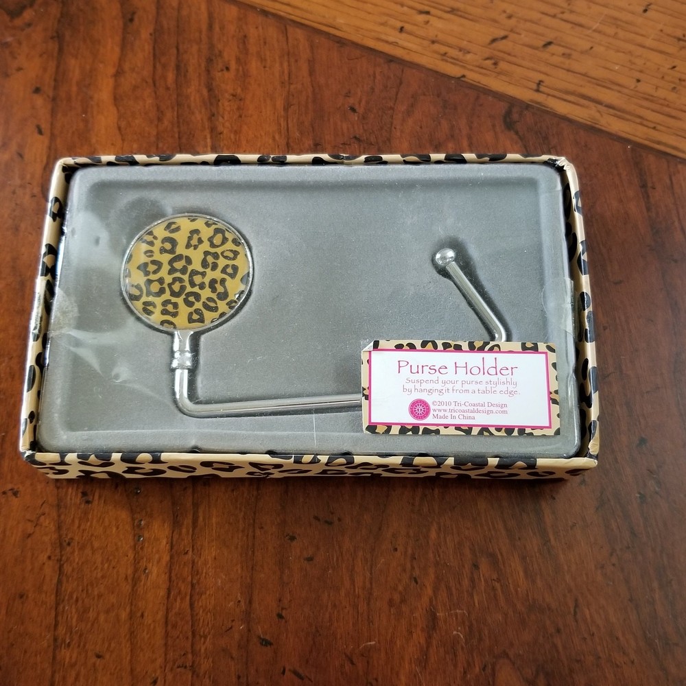 new purse holder hangs purse from table edge.