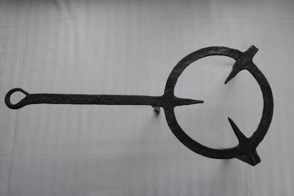 A 18TH CENTURY PRMATIVE FORGED IRON TRIVET
