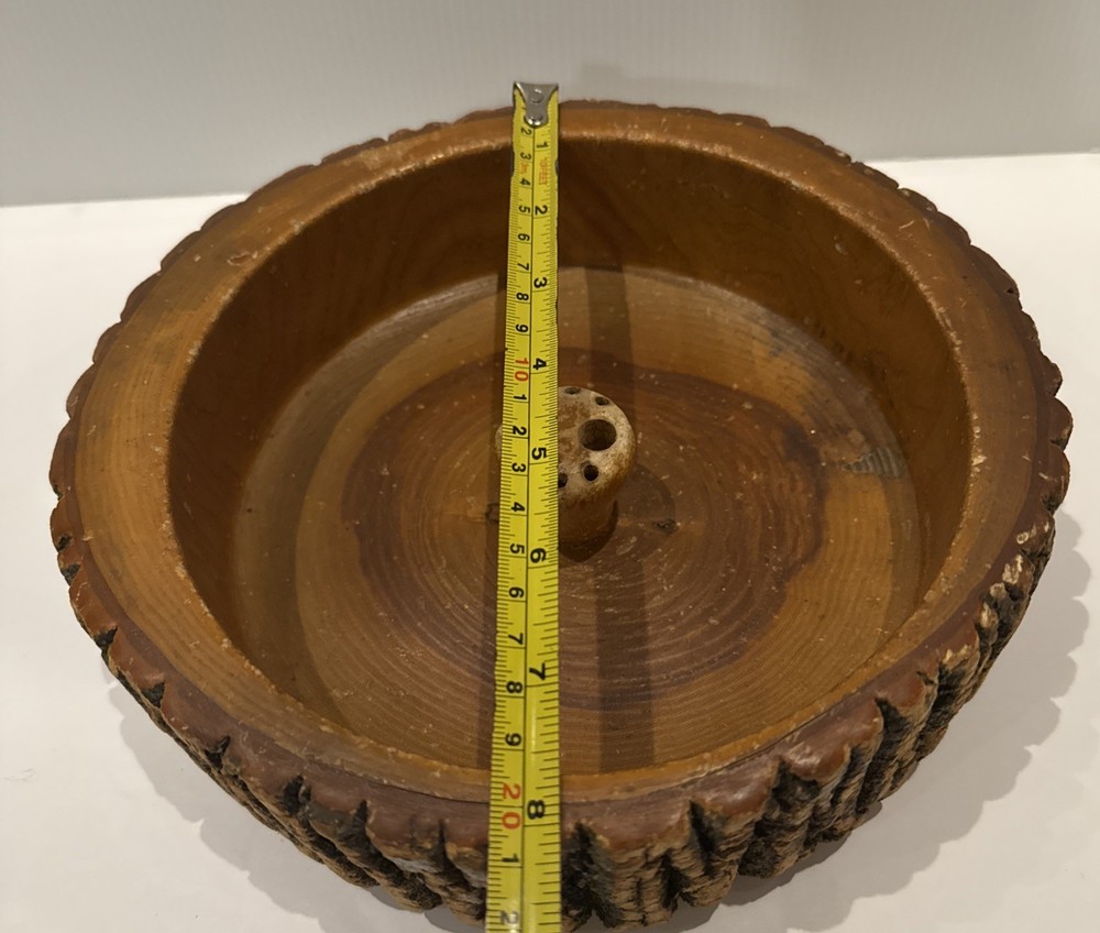 Vintage wooden nut bowl with rustic tree bark,