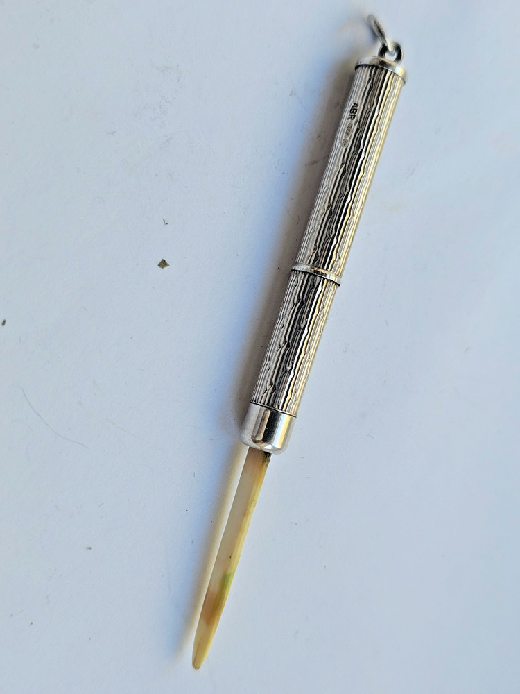 Engine turned silver tooth pick with plastic tool