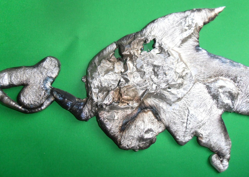 MODERN ART MOLTEN ALUMINUM SPILL FISH CHASING BAIT