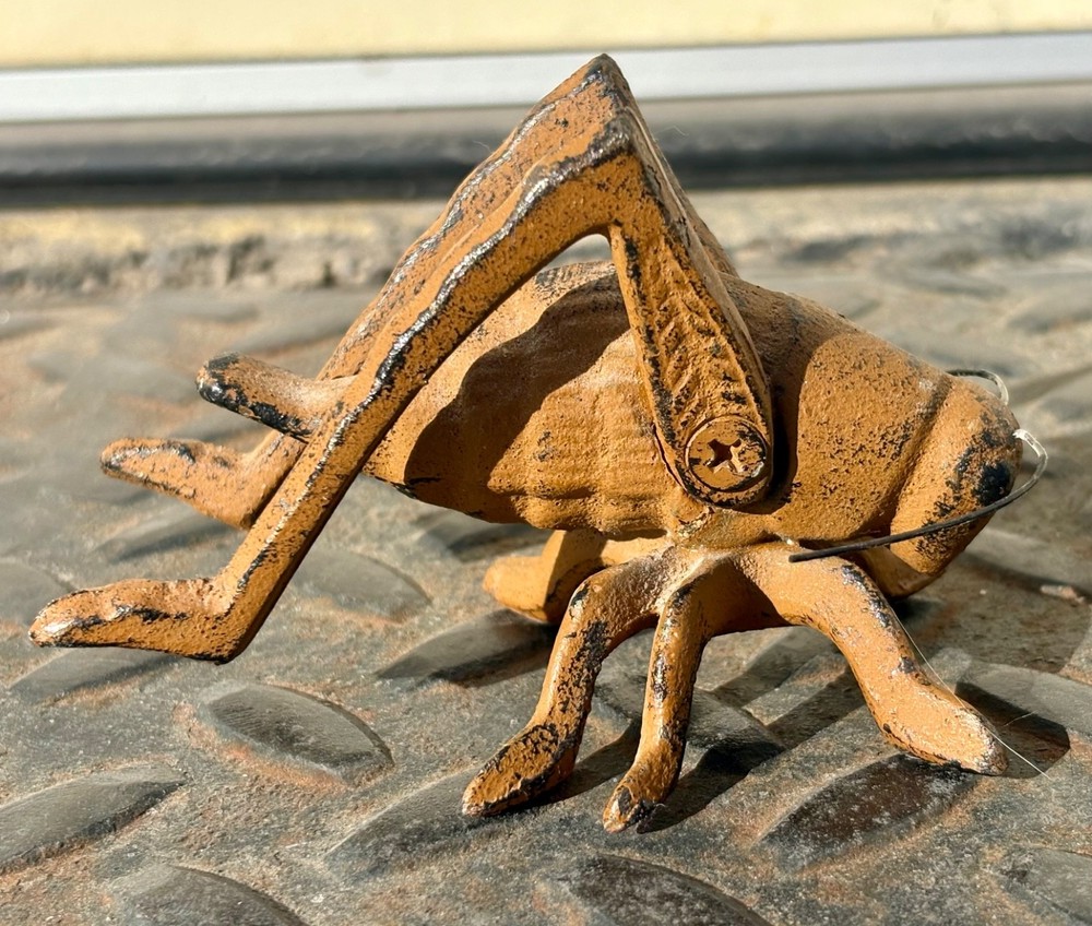 Antique cast iron cricket or grasshopper
