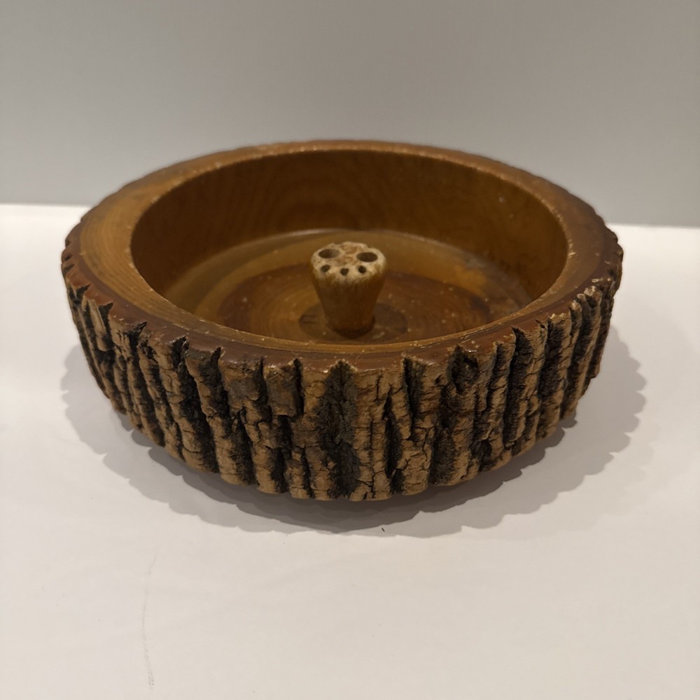 Vintage wooden nut bowl with rustic tree bark,